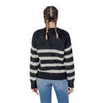 Back view of a woman wearing an Only Black And White Recycled Polyester Sweater, showcasing stripes and texture, perfect for Fall/Winter.