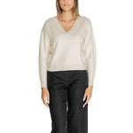 Woman wearing Vero Moda White Viscose Sweater with V-neck and long sleeves, paired with dark jeans, casual chic style.