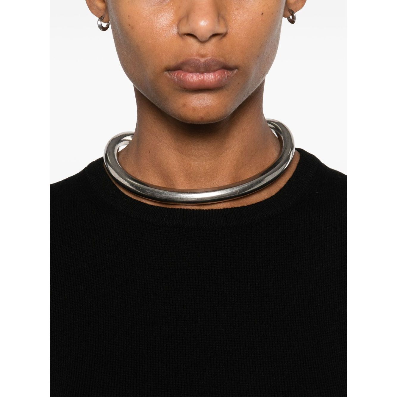 Model wearing black top with silver choker necklace