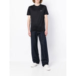 Model wearing Emporio Armani T-shirts and Polos Blue with logo print, crew neck, short sleeves, cotton blend, navy blue lyocell blend fabric.