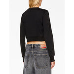 Back view of model wearing Diesel Sweaters Black, a black crew neck cotton blend sweatshirt with long sleeves and cut-out details.