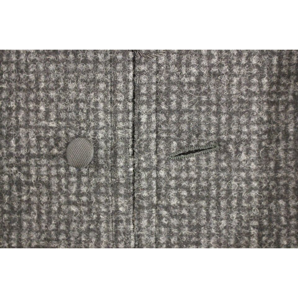 Dolce Gabbana gray wool vest close-up showing button and fabric texture.
