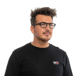 Man wearing Ermenegildo Zegna Black Men Glasses Frame with round plastic frame, full-rim style, and demo lenses, on white background.