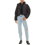 Model wearing Calvin Klein Jeans Black Polyester Jackets & Coat, cropped and stylish, paired with ripped jeans and boots.