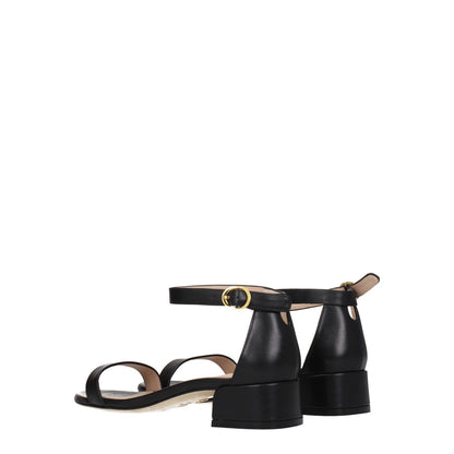 Stuart Weitzman Black Leather Flat Sandals with gold buckle, open toe, mid heels, leather sole, back view.