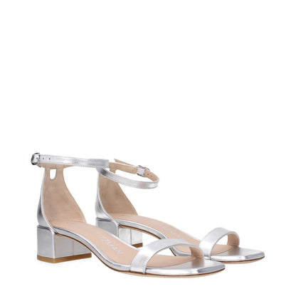 Stuart Weitzman Gray Leather Flat Sandals with buckle closure and mid heels, featuring silver leather and an open toe design.