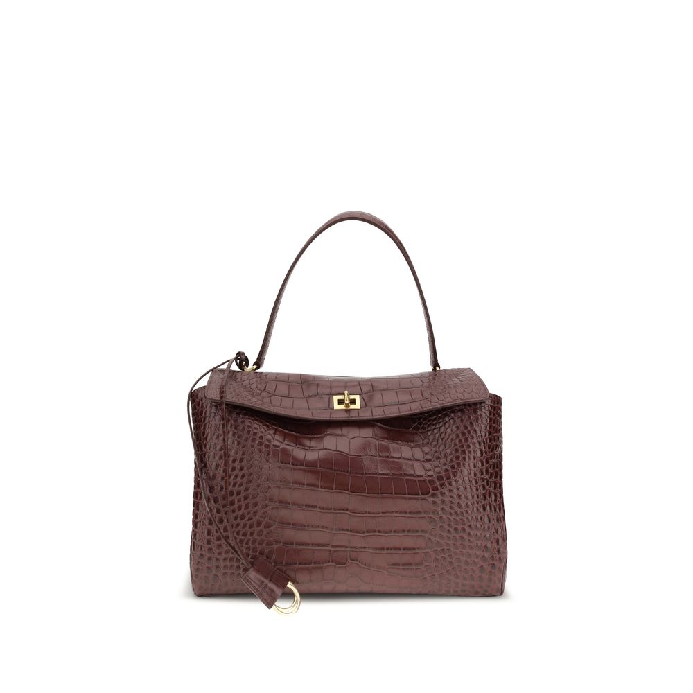 Balenciaga Brown Calf Leather Bos Taurus Handbag with crocodile-effect, single top handle, charm, swivel closure, and dual compartment.