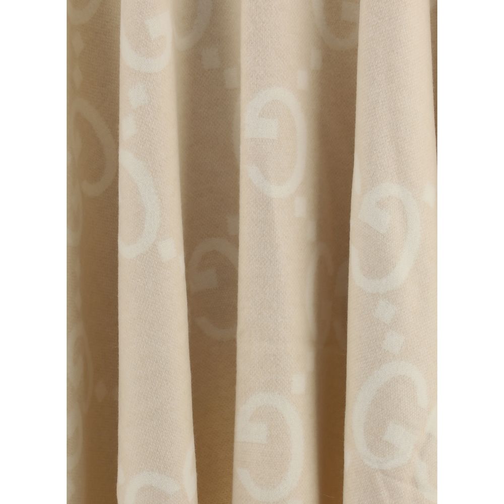 Close-up of Gucci Beige Cashmere Coat fabric with iconic contrasting logo, showcasing luxurious design and texture.