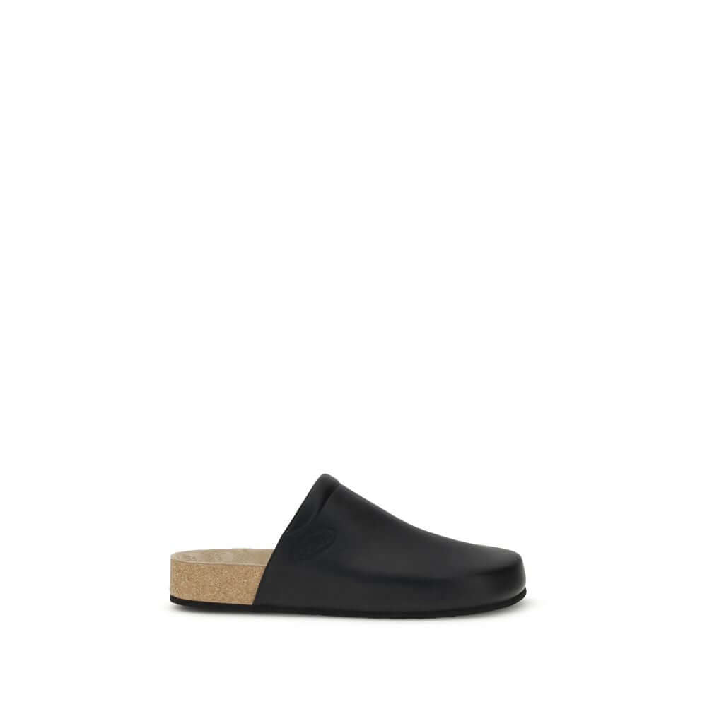Balenciaga Black Calf Leather Bos Taurus Mules with cork insole and minimal design, showcasing sophisticated essential style for AW25 season.