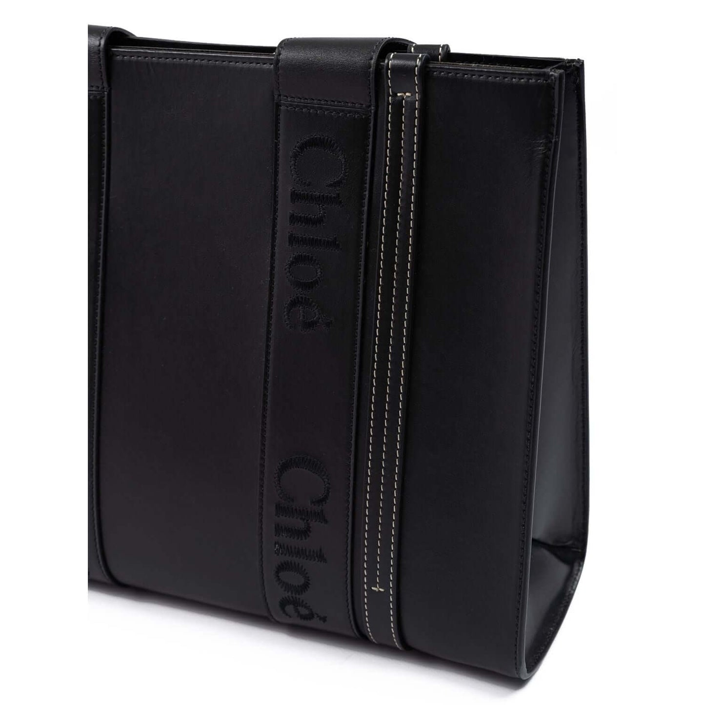 Chloé Black Woody Embroidered Logo Leather Medium Tote Bag with sleek black design and net sustain details, side view