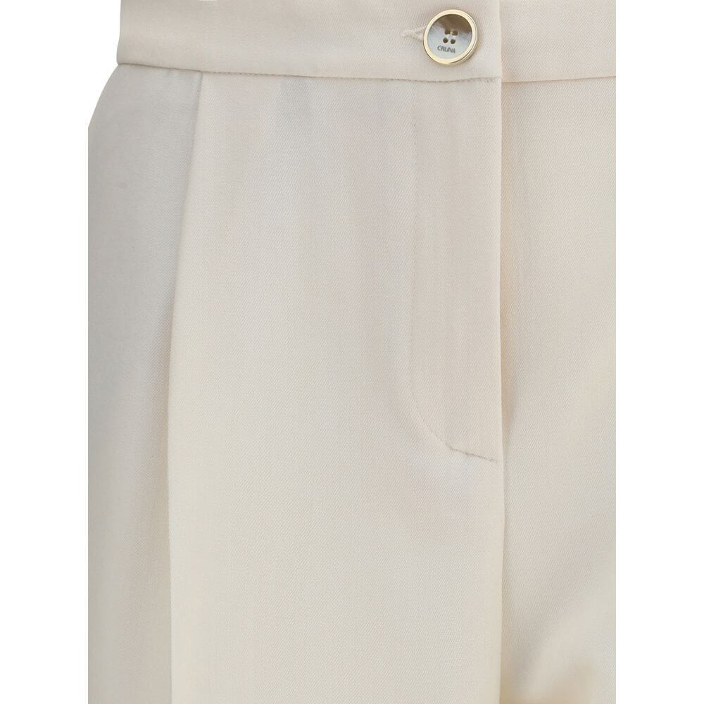 Close-up of Cruna Cream Polyester Casual Pants with button fastening and side pocket detailing.