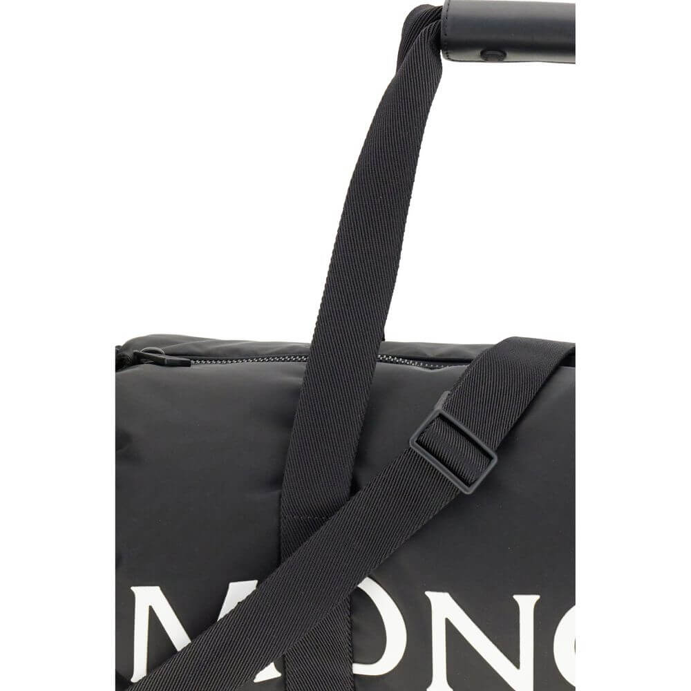 Moncler Black Nylon Luggage And Travel duffle bag with adjustable strap and logo close-up.