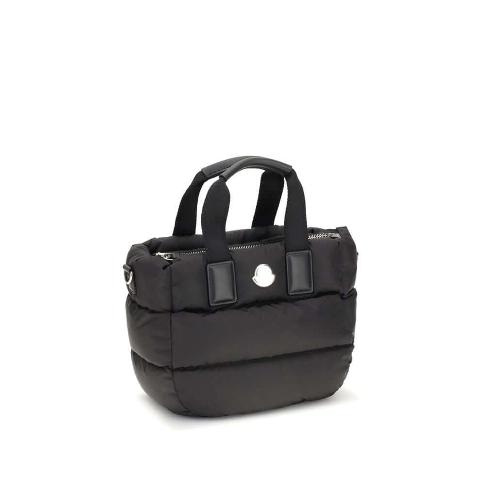Moncler Black Polyamide Handbag with ribbon handles and detachable strap, featuring a metal logo and zip closure, perfect for versatile carrying.