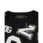 Close-up of Dolce & Gabbana Black Cotton Letter Print Short Sleeve T-shirt with varsity-style logo on black fabric.