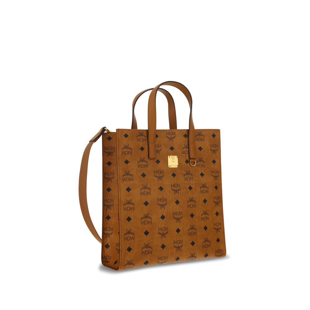 MCM Brown Polyethylene Shoulder Bag with monogram pattern and handle design, front applique plaque, and adjustable strap.