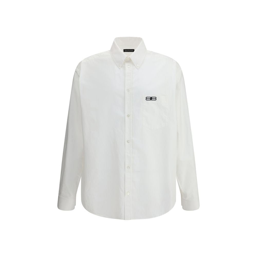 Balenciaga White Cotton Dress Shirt with embroidered logo and asymmetrical hem, featuring classic collar and front button closure, oversize fit.