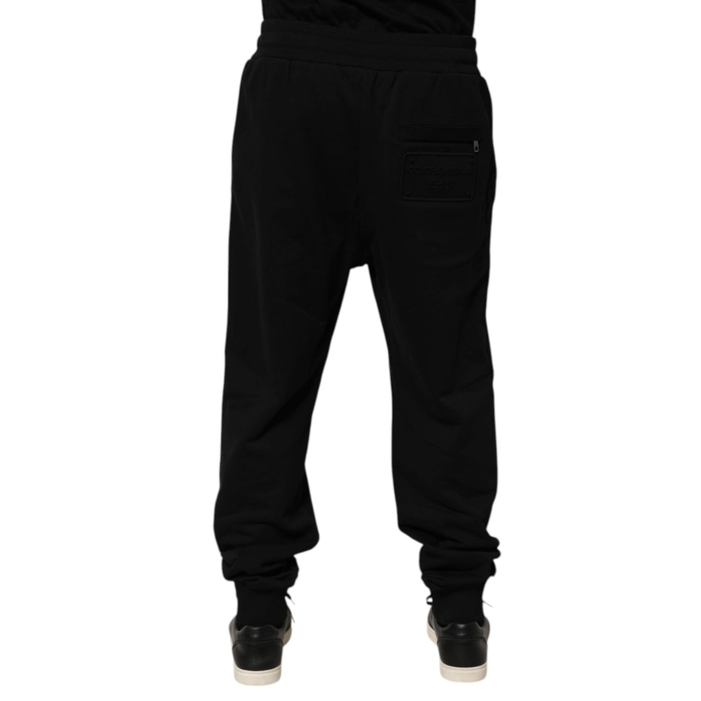 Back view of Dolce & Gabbana Black Cotton Drawstring Logo Sweatpants Pants with ribbed hems and logo patch on pocket.