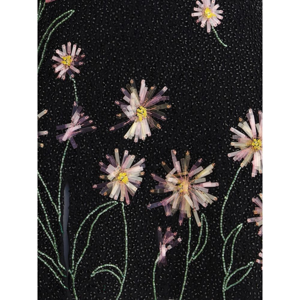 Close-up of floral beading detail on Staud Black Nylon Cocktail Dress, showcasing sequins on black fabric for evening elegance.