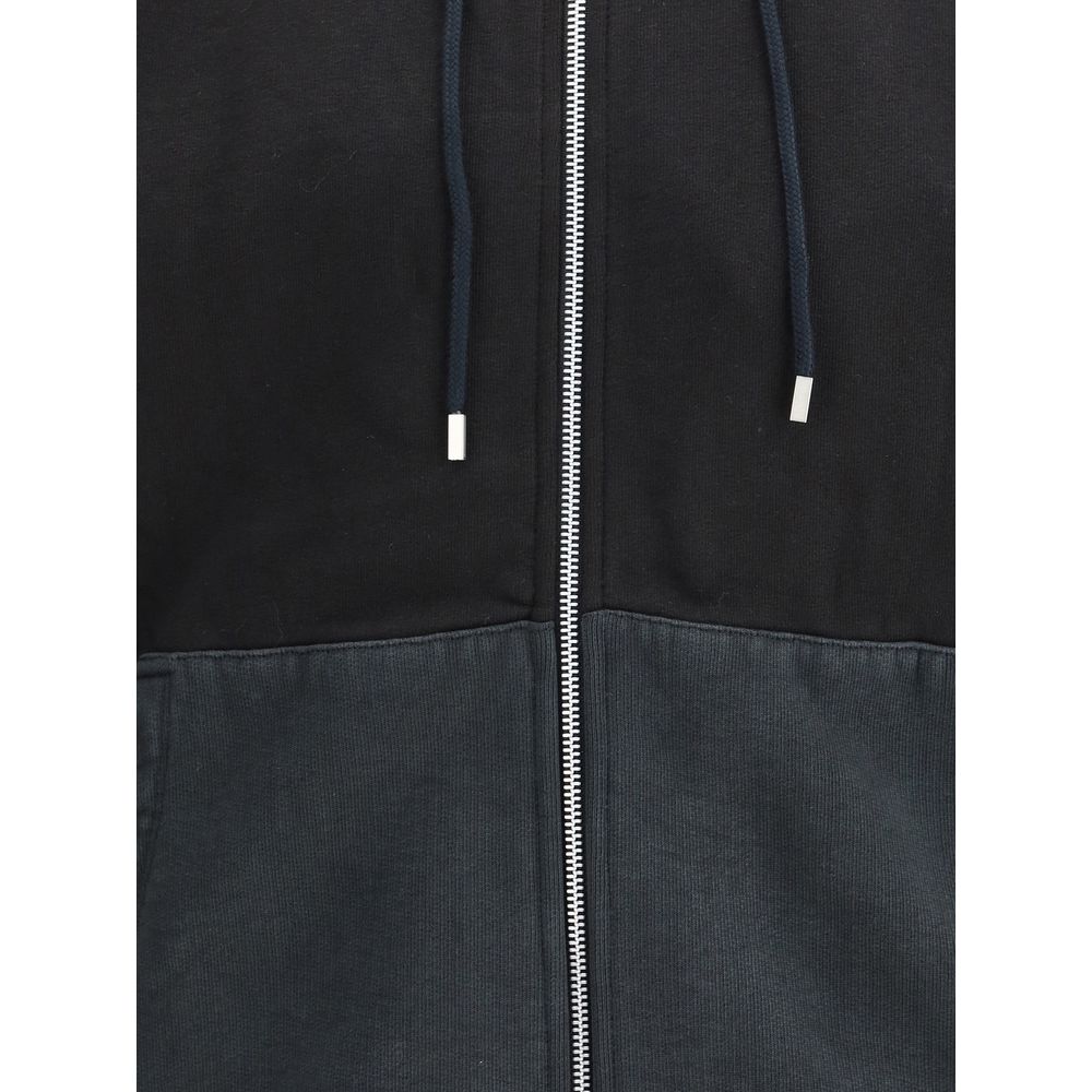 Close-up of Our Legacy Black Cotton Sweatshirt showing drawstring hood and two-way zip detail
