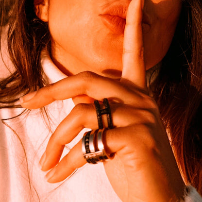 Woman wearing AN JEWELS JEWELRY Mod. AR.R2NS02BK-8 rings, making a shushing gesture with her finger on her lips.