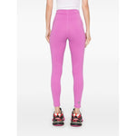 Back view of Adidas By Stella McCartney Trousers Purple, fuchsia pink with logo print at the leg, worn by a model.