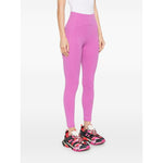 Woman wearing Adidas By Stella McCartney Trousers Purple, fuchsia pink leggings with logo and tonal stitching, elasticated waistband.