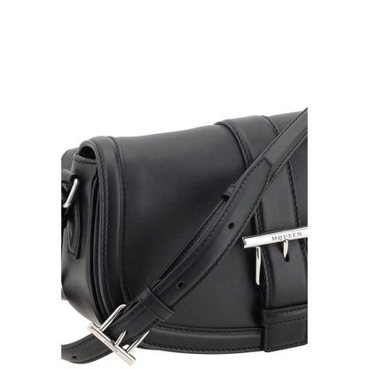 Close-up view of Alexander McQueen Black Calf Leather Bos Taurus Shoulder Bag with adjustable strap and silver buckle detail.