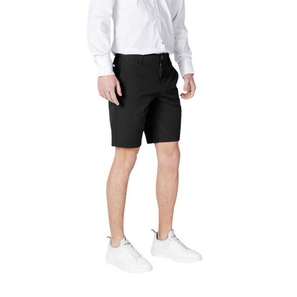 Armani Exchange Black Polyamide Bermuda Shorts worn by a model with white shirt and sneakers, front view.