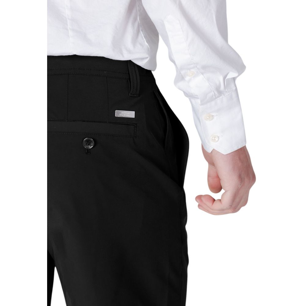 Man wearing Armani Exchange Black Polyamide Bermuda Shorts with buttoned white shirt, showcasing back pocket detail.