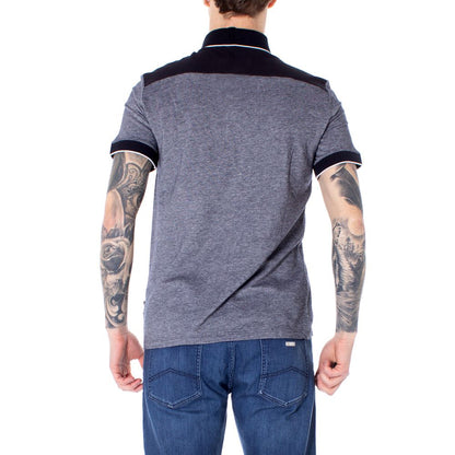 Back view of model wearing Armani Exchange Blue Cotton Polo Shirt, showcasing short sleeves and fine design details for casual wear.