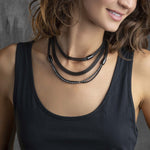 Woman wearing BREIL JEWELS Mod. TJ2938 bracelet with elegant black design, shown in an official box packaging.