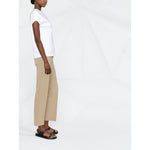 Side view of a model wearing Brunello Cucinelli Chain-trim round-neck t-shirt, white cotton, short sleeves, paired with beige pants.