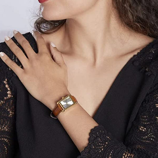 CASIO COLLECTION Mod. TANK. LEATHER - ARGENTEE wristwatch worn by a woman, featuring a gold SS IP case and leather strap, in close-up view.