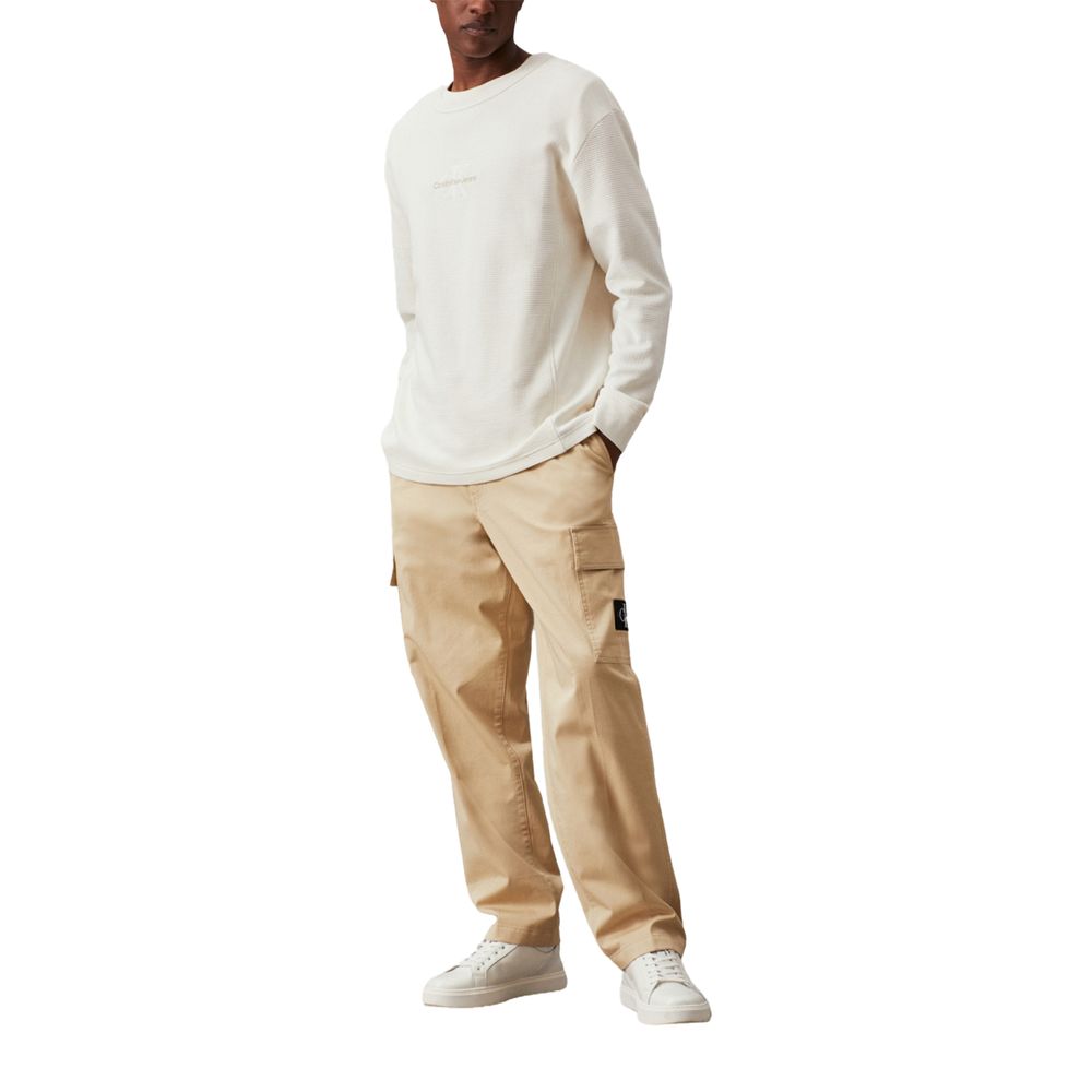 Model wearing Calvin Klein Jeans Beige Recycled Cotton Cargo Pants with a white shirt and sneakers