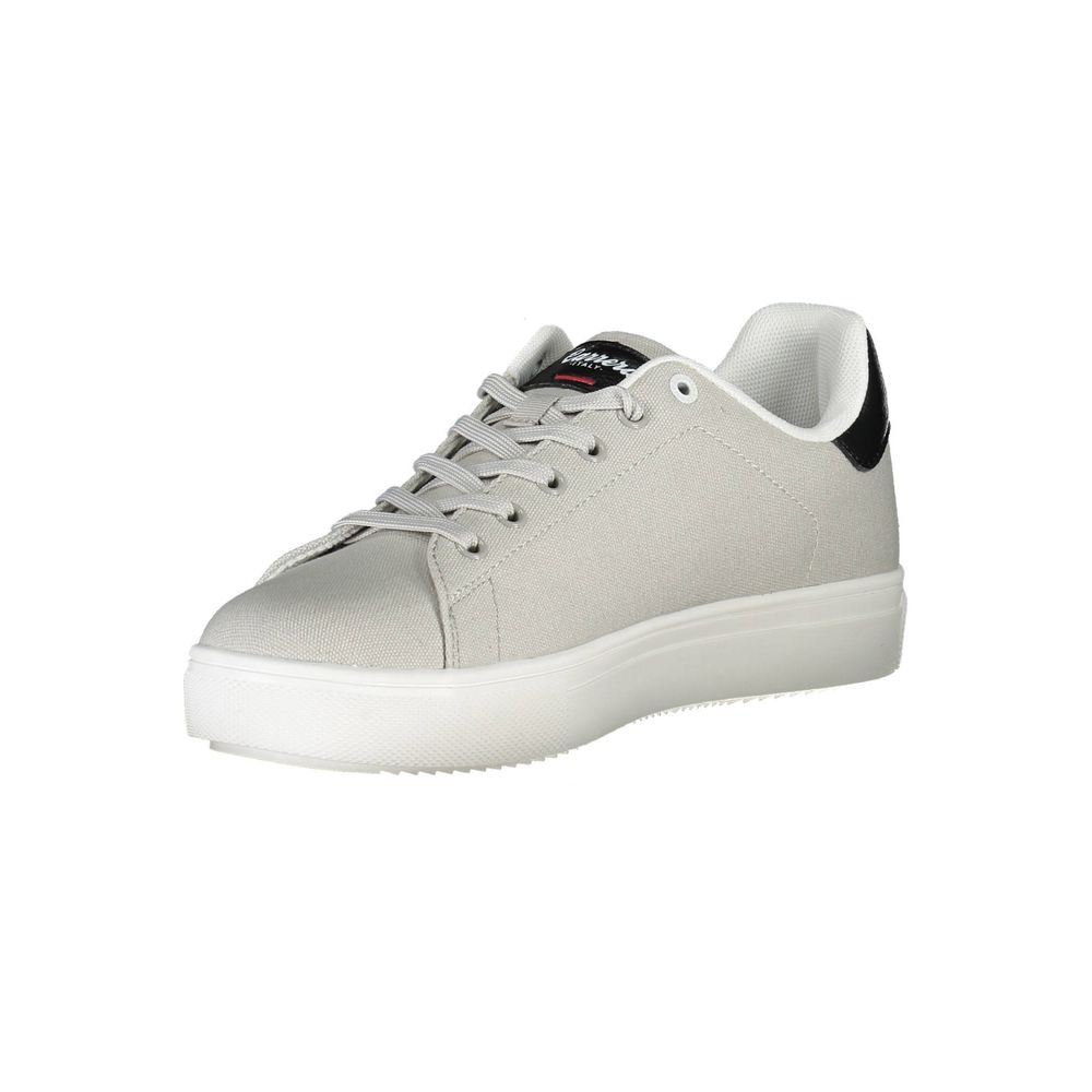 Gray and black casual canvas sneaker with white sole, featuring lace-up design and brand logo detail on the tongue.