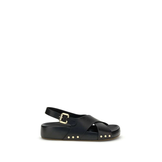 Chloé Mae Sandals in black calfskin with gold studs, featuring crossed straps and Paddington buckle ankle strap.