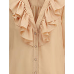 Close-up of Chloé Ruffle Shirt in silk with V-neckline and ruffle details, featuring mother-of-pearl buttons. Elegant and feminine design.