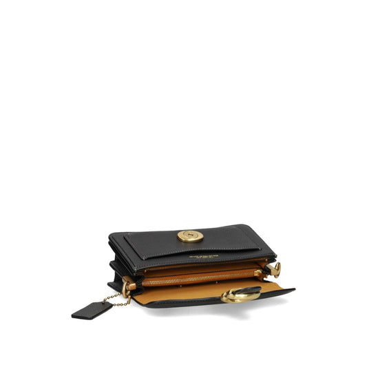 Black Coach Tabby 20 leather crossbody bag open showing multifunctional pockets and snap closure with removable shoulder strap.
