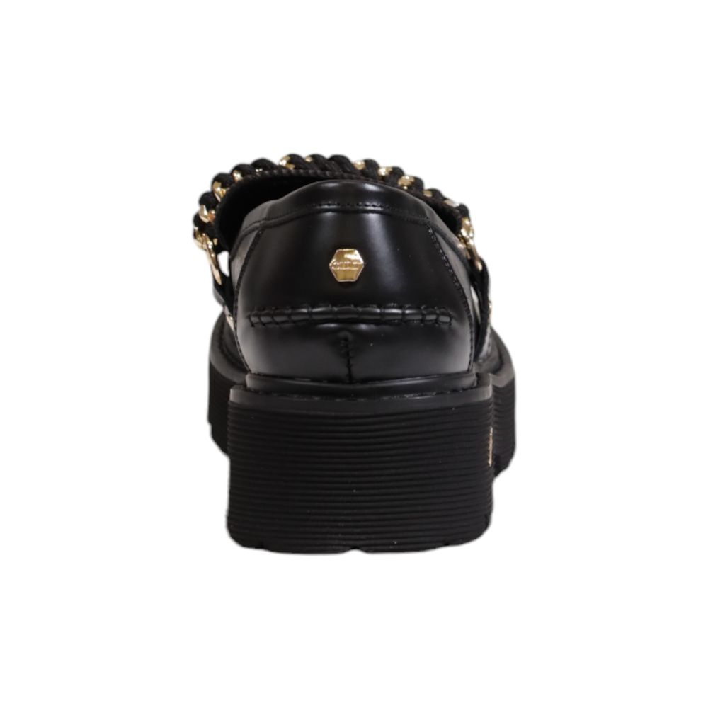 Rear view of Cult Black Leather Platform shoes with chain detail and chunky treaded sole, showcasing elegant brushed leather finish.