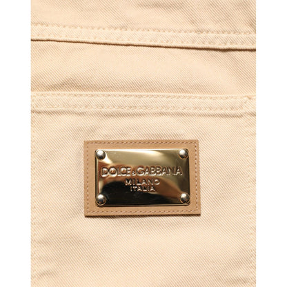 Close-up of Dolce & Gabbana Beige Cotton Skinny Regular Men Denim Jeans with logo patch on back pocket.