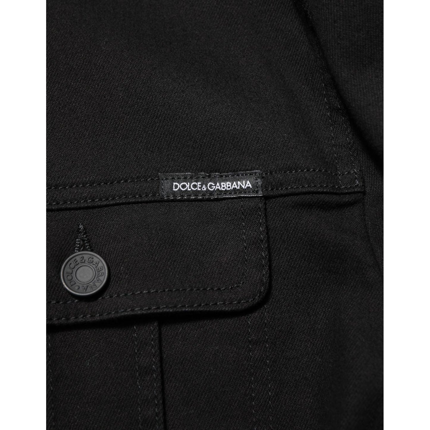 Close-up of Dolce & Gabbana Black Cotton Denim Stretch Giubbotto Jacket showing button and logo details.