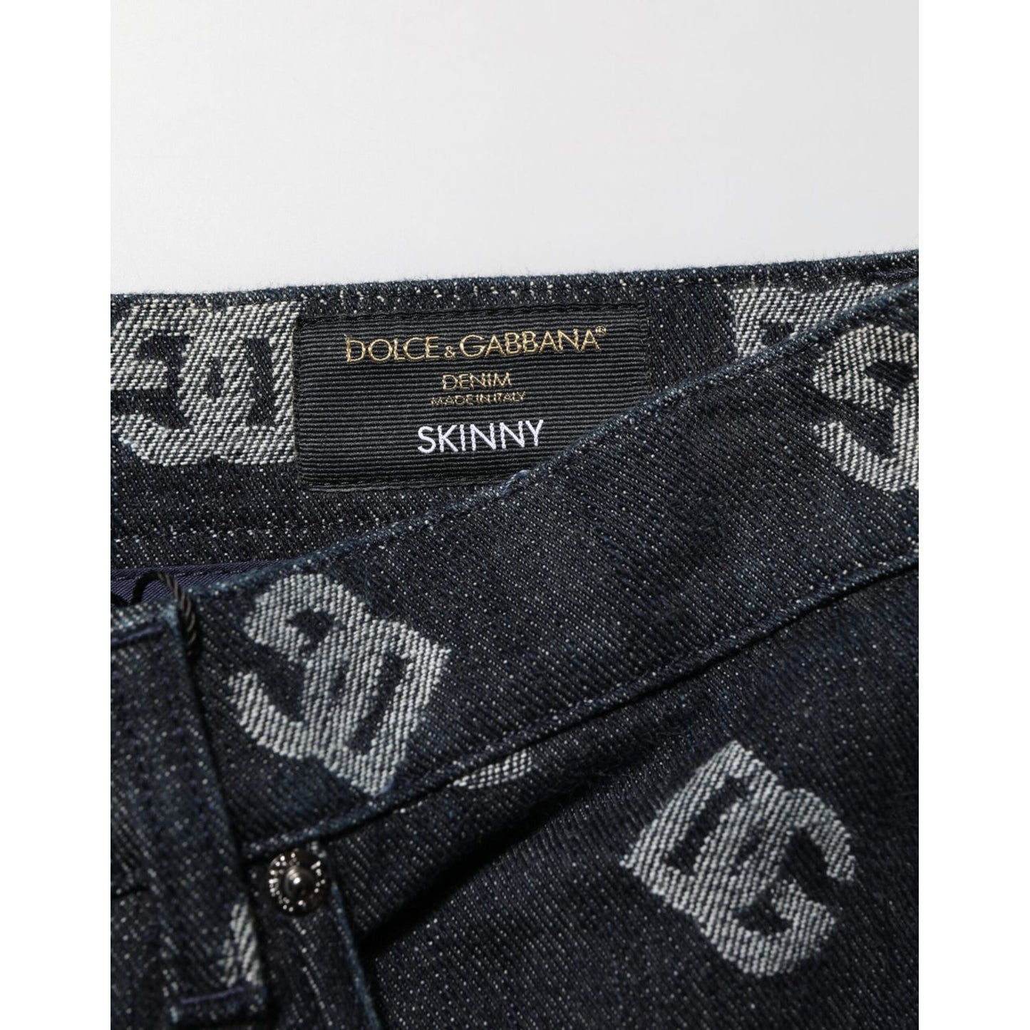 Close-up of Dolce & Gabbana Black DG Monogram Cotton Skinny Denim Jeans showcasing the label and DG monogram design.