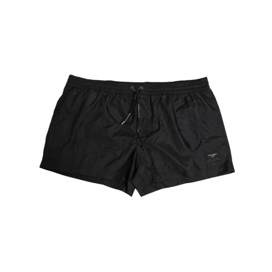 Dolce & Gabbana Black Logo Polyester Beachwear Shorts Swimwear, sleek swim shorts with elastic waist and iconic logo detail.