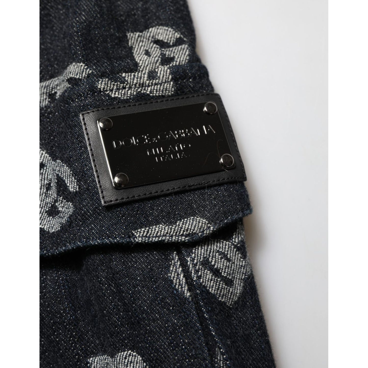 Close-up of Dolce & Gabbana Black Monogram Denim Cargo Men Bermuda Short showing monogram details and metal logo plaque.