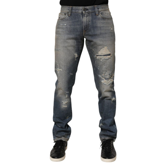 Dolce & Gabbana Blue Distressed Denim Slim Fit Pants Jeans with ripped details and leather logo patch.