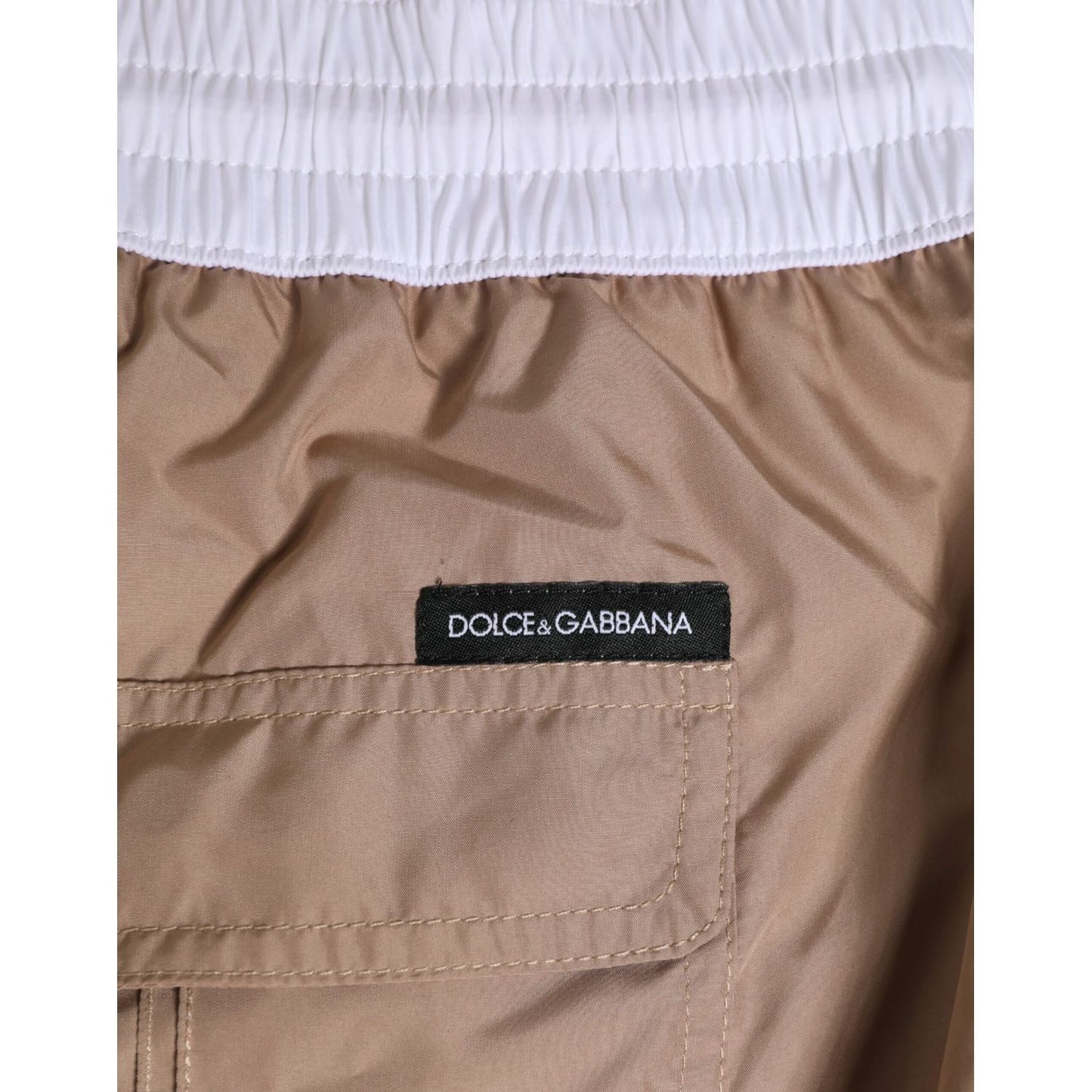 Dolce & Gabbana Brown White Polyester Re-Edition Shorts Swimwear detail with logo and elastic waistband.