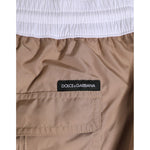 Dolce & Gabbana Brown White Polyester Re-Edition Shorts Swimwear detail with logo and elastic waistband.
