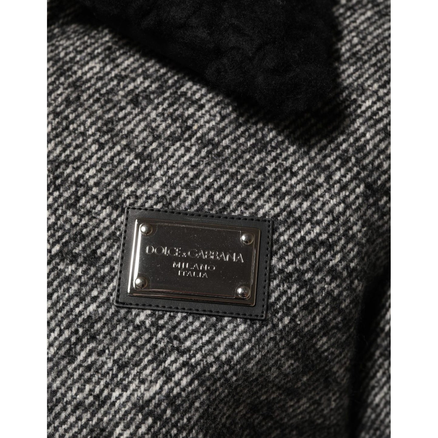 Close-up of Dolce & Gabbana Gray Wool Herringbone Shearling Collar Bomber Jacket with logo patch detail.