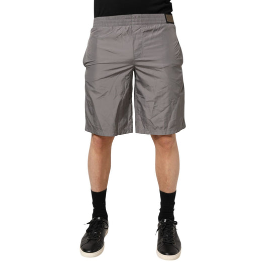 Model wearing Dolce & Gabbana Light Gray Nylon Elastic Waist Shorts Swimwear, showcasing sleek and minimalist Italian craftsmanship.