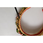 Close-up of Dolce & Gabbana Multicolor Crystal Floral Gold Green Velvet Crown Headband with woven base and embellishments.